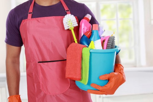 Cleaner preparing a safe and organised cleaning area